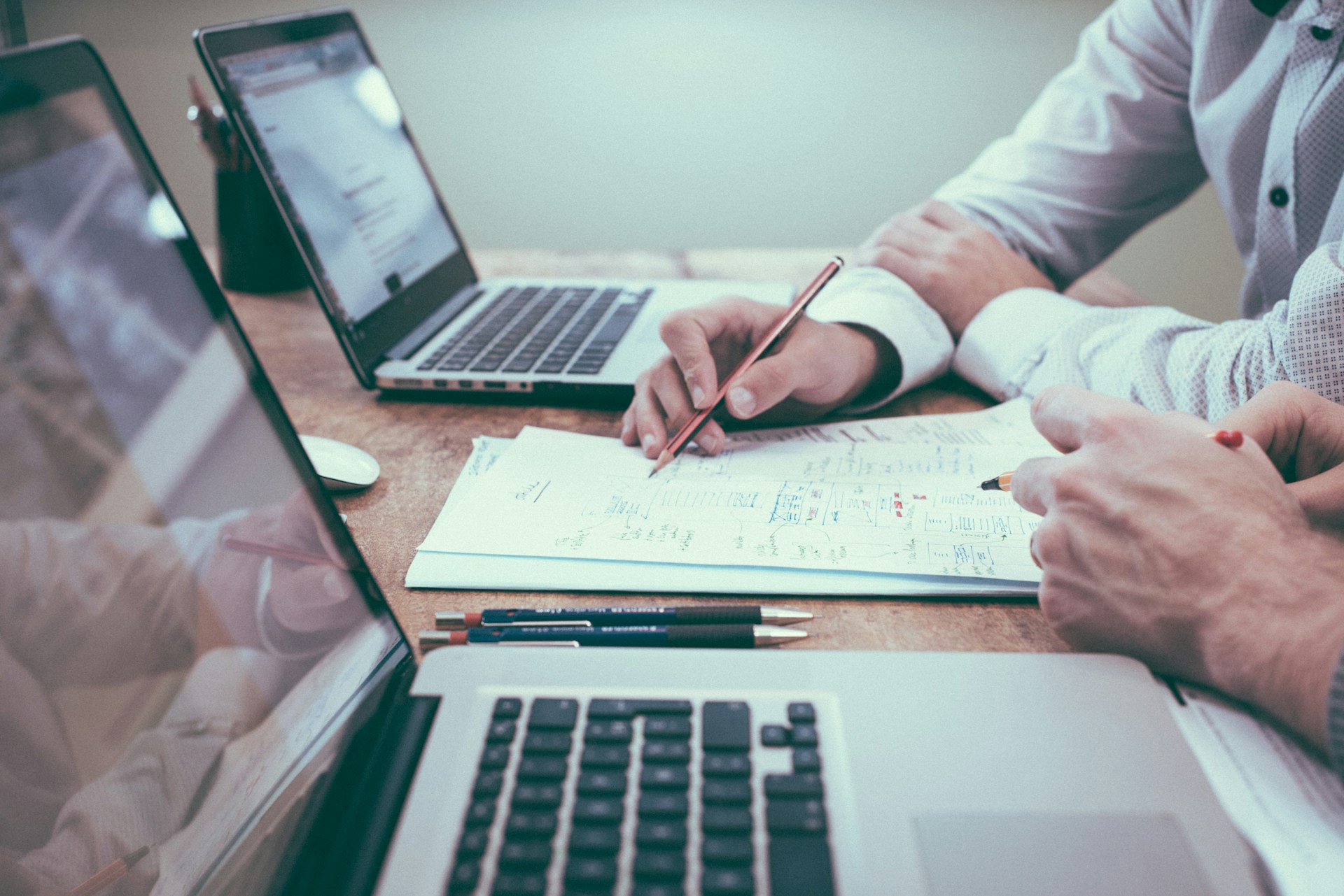 Operations planning desk with checklist, laptop, and coffee — representing structured business procedures